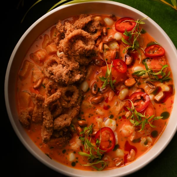 Mikhuna Japanese-Peruvian Cuisine's seafood dish with fried calamari, red peppers, and microgreens.